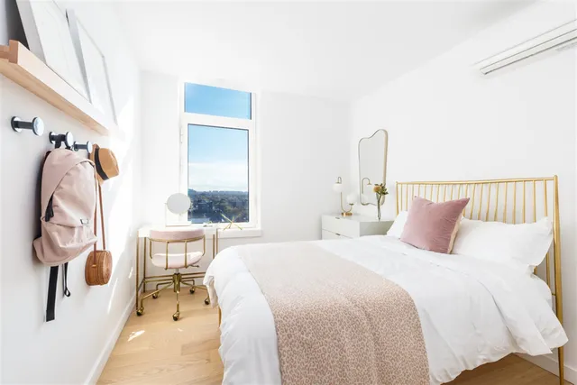 a bedroom with a bed and a mirror