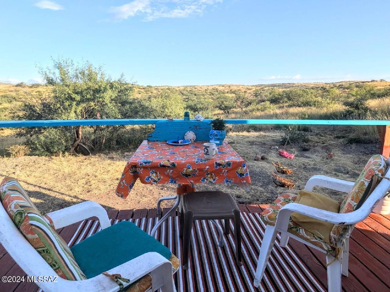 35700 South Cedar Creek Road Arivaca, AZ 85601 - Photo 38 of 44 a view of a balcony with two chairs and a table