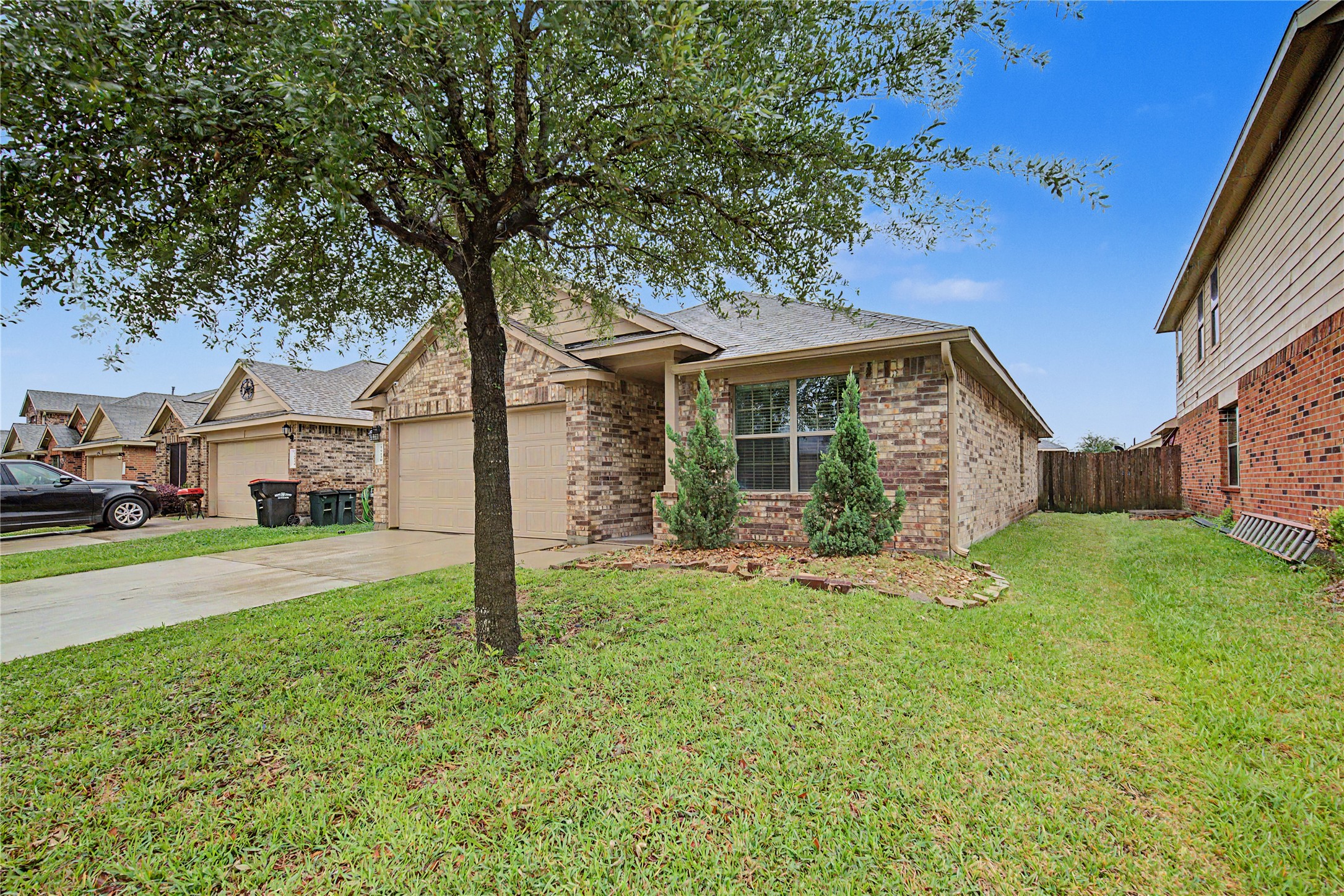 16430 Rodeo River Road Houston, TX 77049 - Photo 3 of 34 a front view of a house with a yard and garage