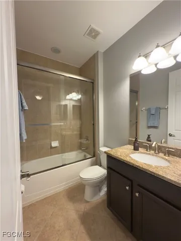a bathroom with a sink vanity mirror and toilet