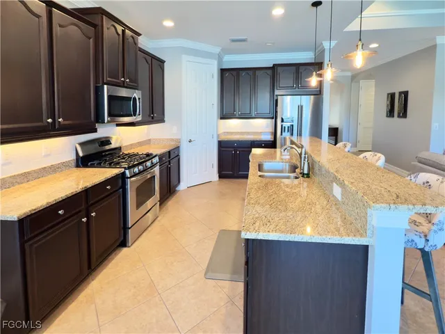 a kitchen with kitchen island granite countertop wooden cabinets and stainless steel appliances