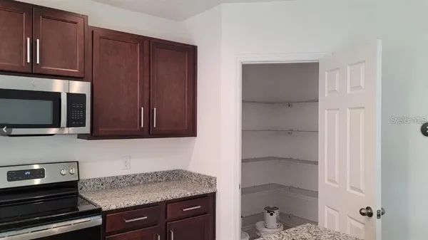 a kitchen with sink cabinets and microwave