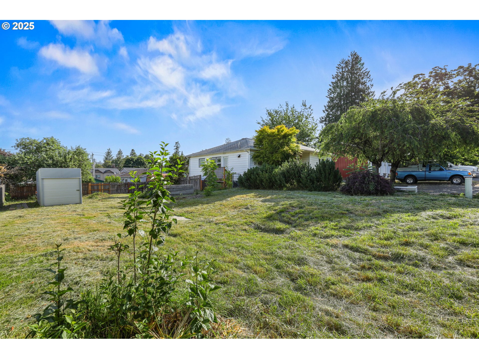 a backyard of a house with lots of green space
