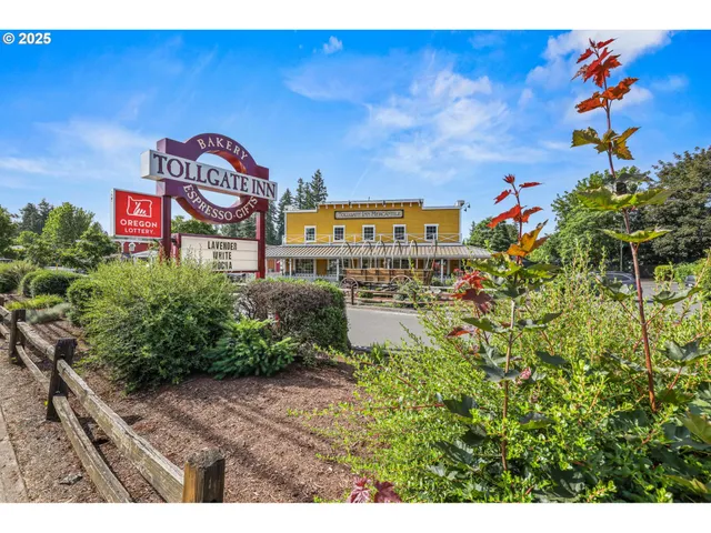 a sign board with a house and yard at the back