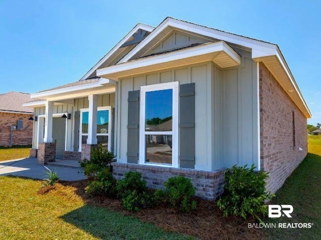 13791 Logan Place Foley, AL 36535 - Photo 3 of 25 Contemporary facade featuring board and batten siding with brick accents