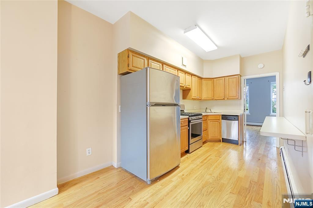 523 Adams Street, Unit 3 Hoboken, NJ 07030 - Photo 12 of 19 a kitchen with stainless steel appliances a refrigerator and a stove top oven