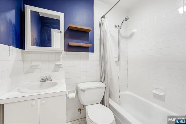a bathroom with a toilet sink and shower