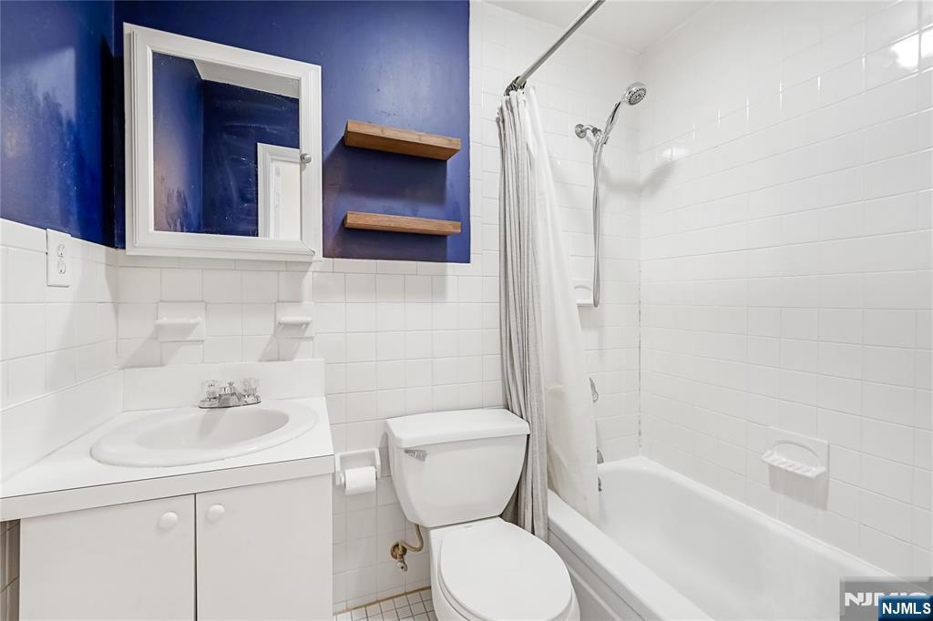 523 Adams Street, Unit 3 Hoboken, NJ 07030 - Photo 13 of 19 a bathroom with a toilet sink and shower