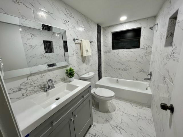 4372 Lamson Avenue Spring Hill, FL 34608 - Photo 3 of 8 a bathroom with a sink a toilet a mirror and bathtub