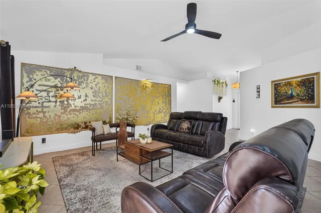 a kitchen with stainless steel appliances granite countertop a refrigerator a stove a sink a microwave and a refrigerator