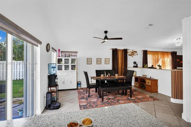 a view of hallway with granite countertop a sink and a refrigerator