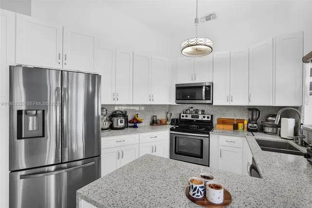 a kitchen with a refrigerator and cabinets