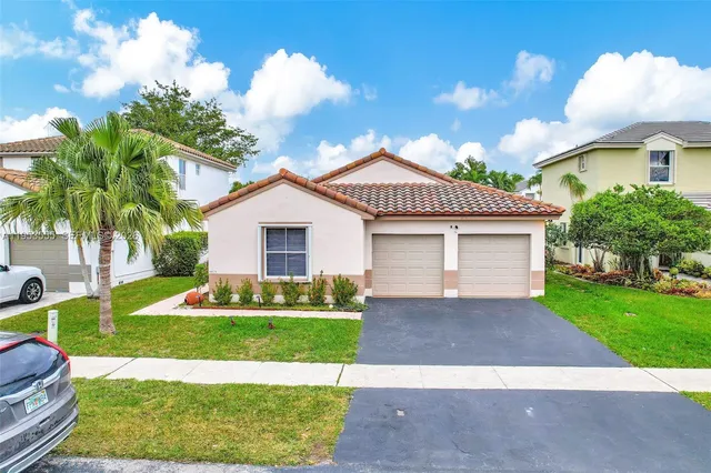 a view of backyard with swimming pool and sitting area