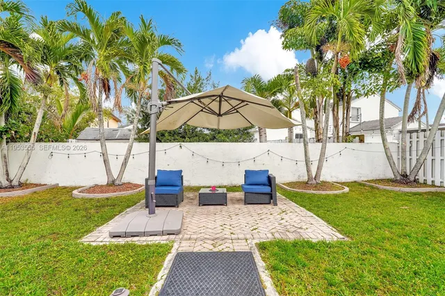 a view of a backyard with swimming pool