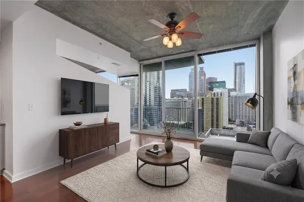 a living room with furniture and a flat screen tv