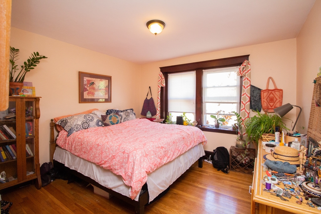 55 Franklin Street, Unit 1 Brookline, MA 02445 - Photo 11 of 12 a bed room with a bed and a large window