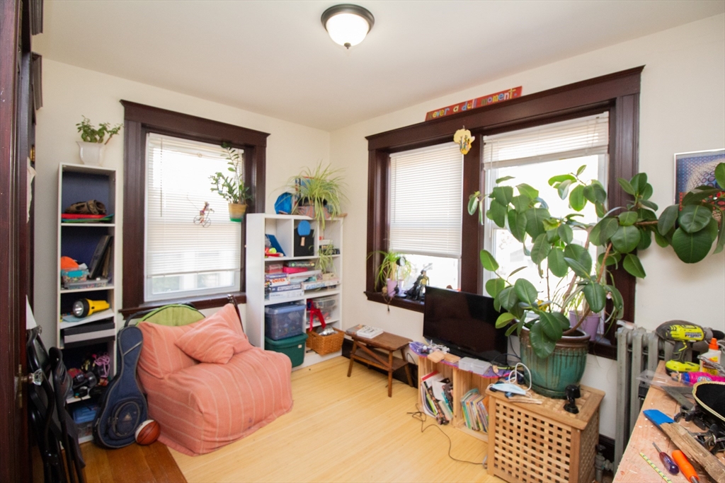 55 Franklin Street, Unit 1 Brookline, MA 02445 - Photo 12 of 12 a living room filled with furniture and a potted plant