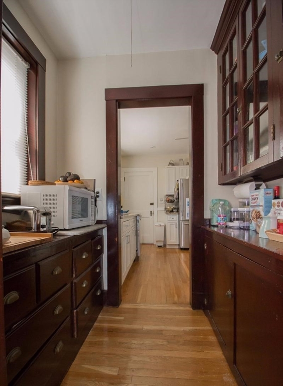 55 Franklin Street, Unit 1 Brookline, MA 02445 - Photo 6 of 12 a kitchen with a sink and cabinets