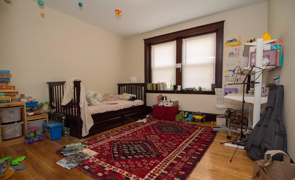 55 Franklin Street, Unit 1 Brookline, MA 02445 - Photo 7 of 12 a bedroom with furniture and a window