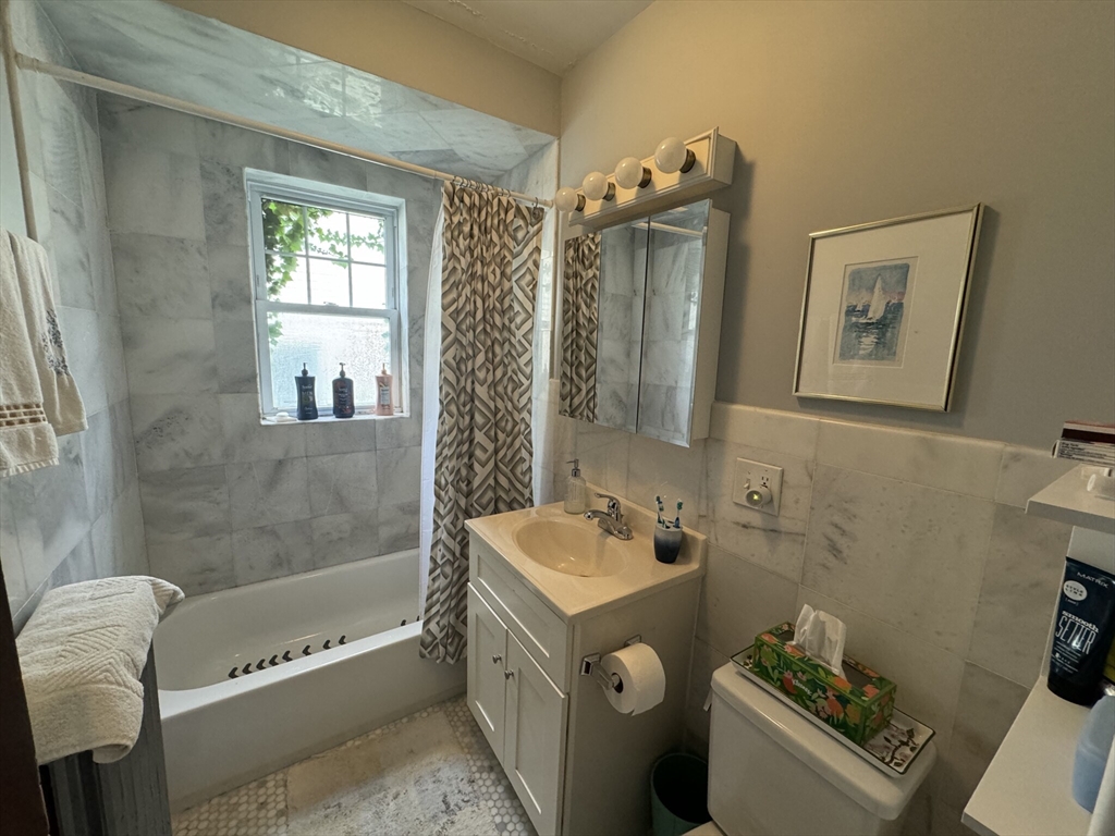 55 Franklin Street, Unit 1 Brookline, MA 02445 - Photo 10 of 12 a bathroom with a tub a sink and a shower