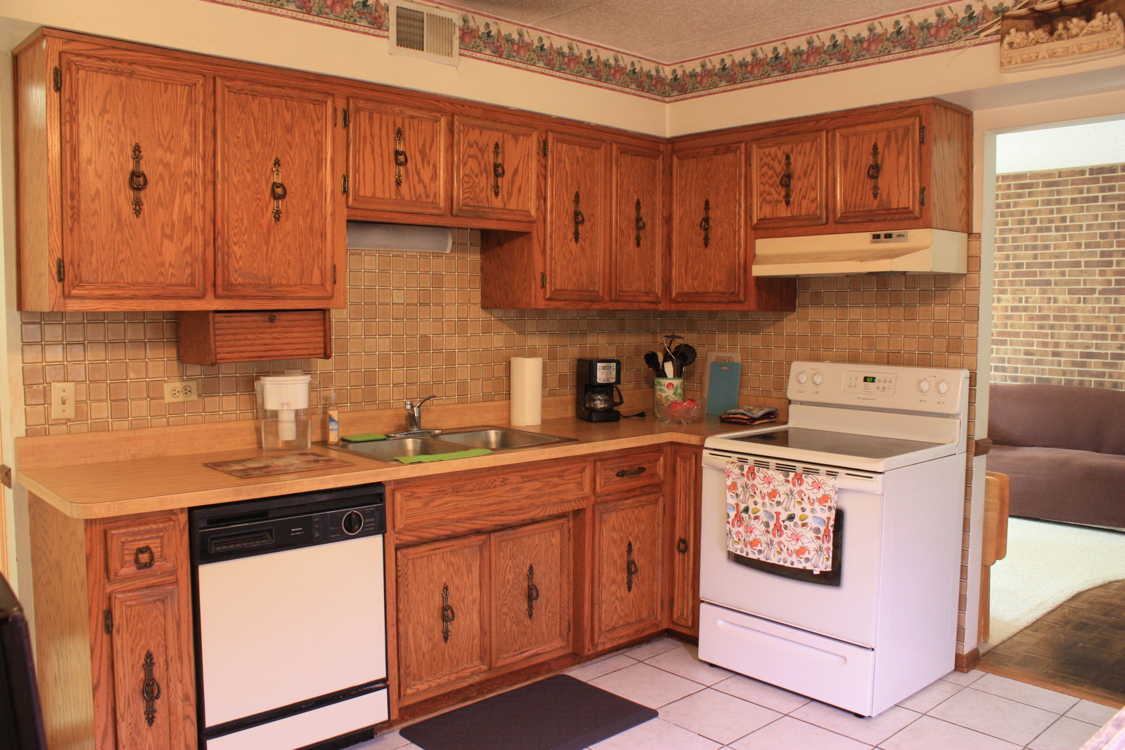 10900 Central Avenue, Unit 2C Chicago Ridge, IL 60415 - Photo 10 of 16 a kitchen with stainless steel appliances granite countertop a sink stove and cabinets