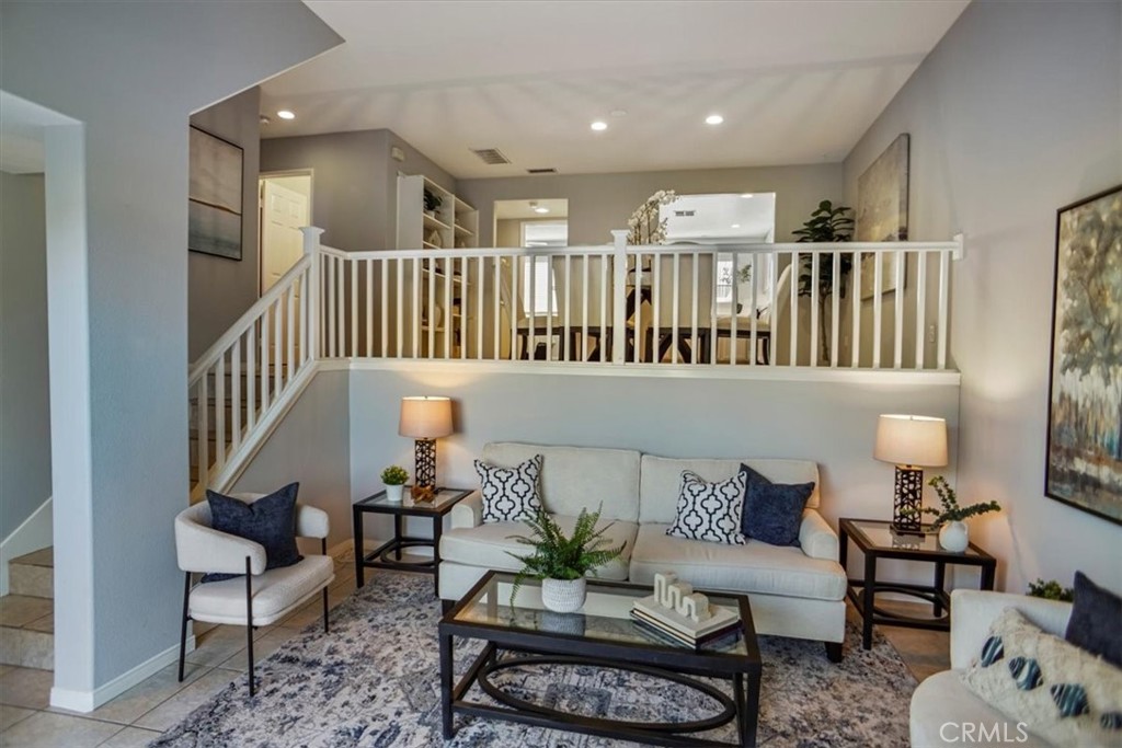 25708 Holiday Circle, Unit B Stevenson Ranch, CA 91381 - Photo 1 of 1 a living room with furniture and a wooden floor