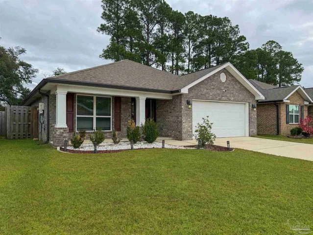 a view of a house with a yard and sitting area