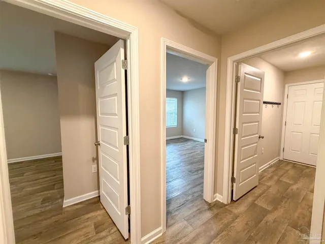a view of a hallway with wooden floor