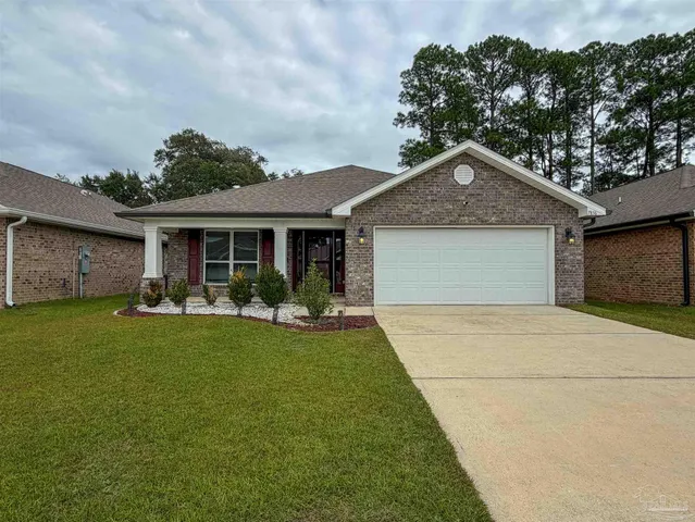 a front view of a house with a garden and porch