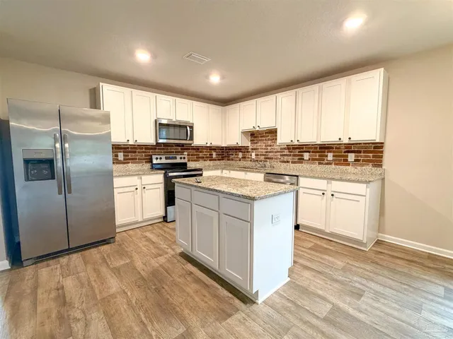a kitchen with a white cabinets and white appliances