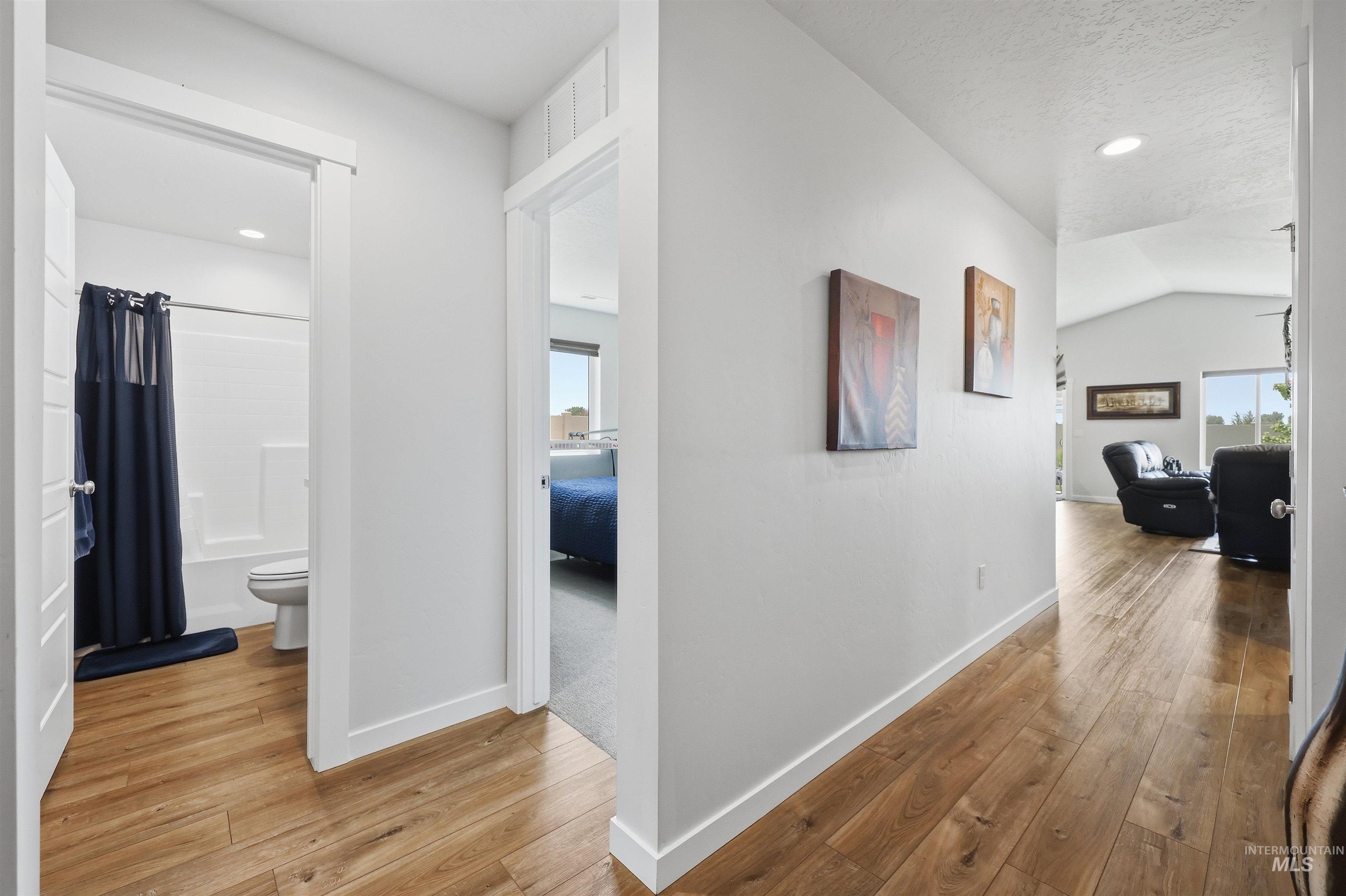 3811 West Maypearl Street Meridian, ID 83642 - Photo 6 of 39 Hallway featuring wood-finish flooring and recessed lighting