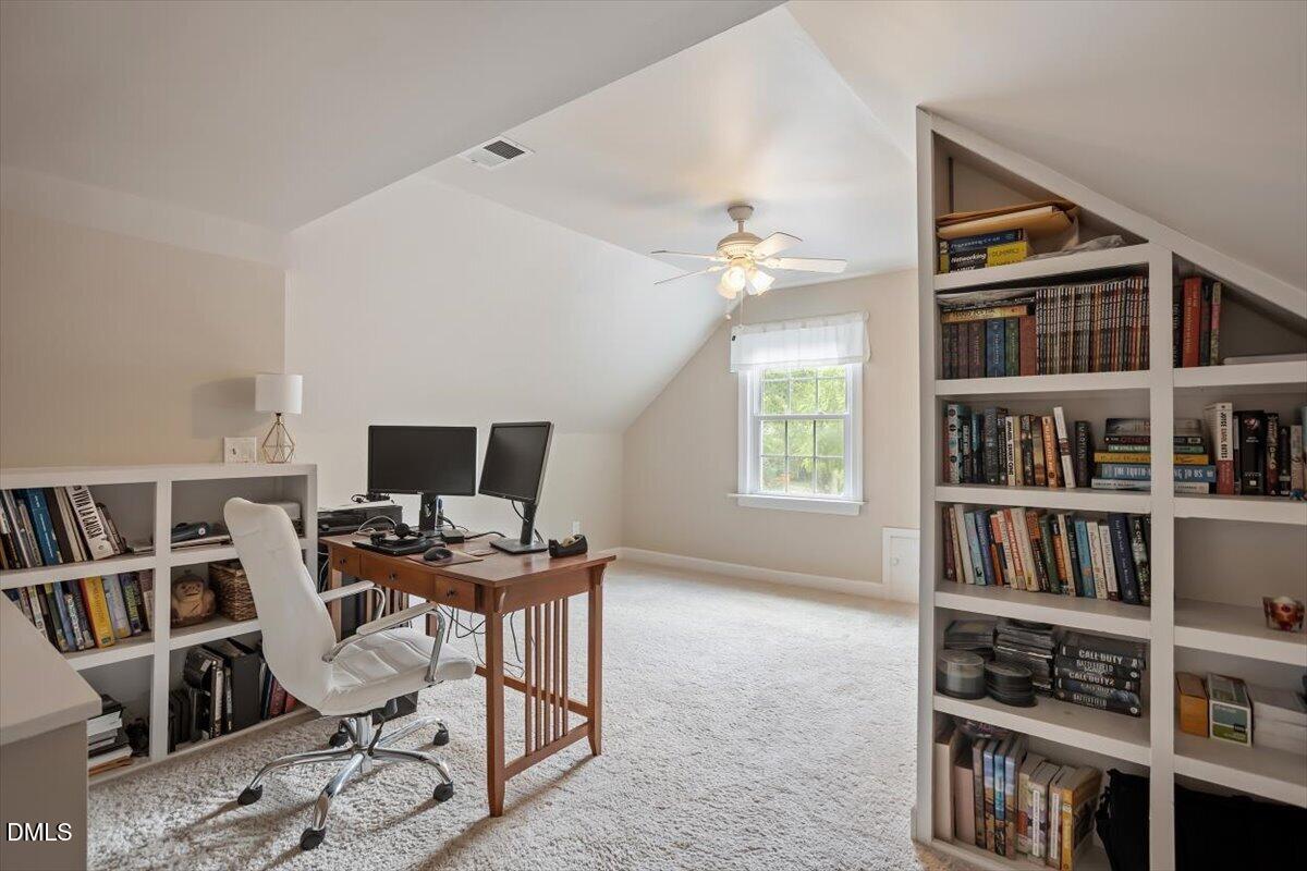 1808 Thorpshire Drive Raleigh, NC 27615 - Photo 16 of 17 a workspace with furniture and a bookshelf