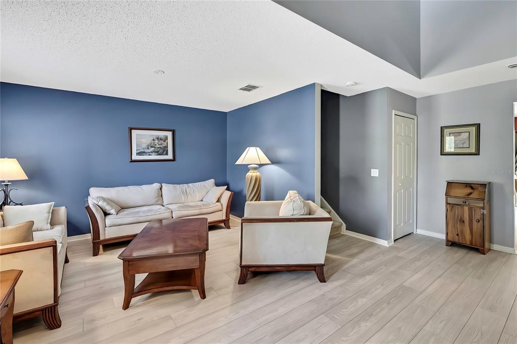 11257 Persimmon Avenue Weeki Wachee, FL 34614 - Photo 11 of 50 a living room with furniture and a lamp