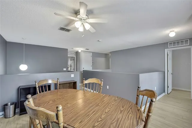 a view of a dining room with furniture and window