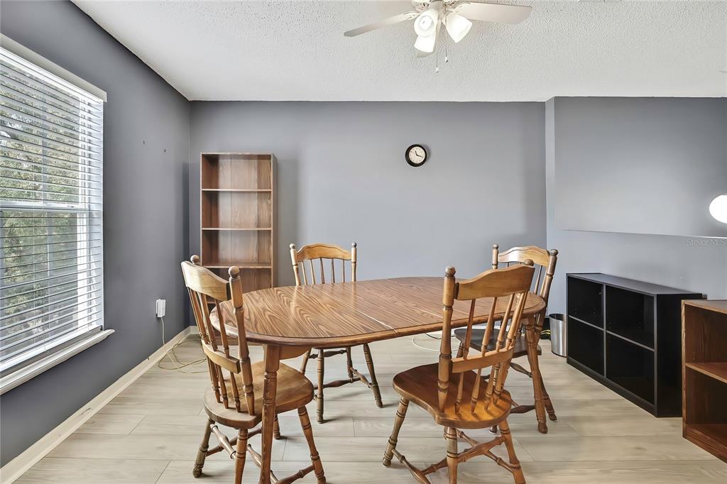 11257 Persimmon Avenue Weeki Wachee, FL 34614 - Photo 14 of 50 a view of a dining room with furniture and window