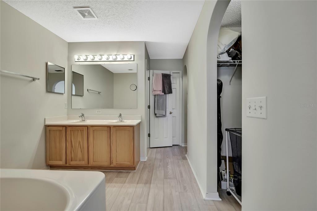 11257 Persimmon Avenue Weeki Wachee, FL 34614 - Photo 19 of 50 a bathroom with a sink a mirror and a bathtub