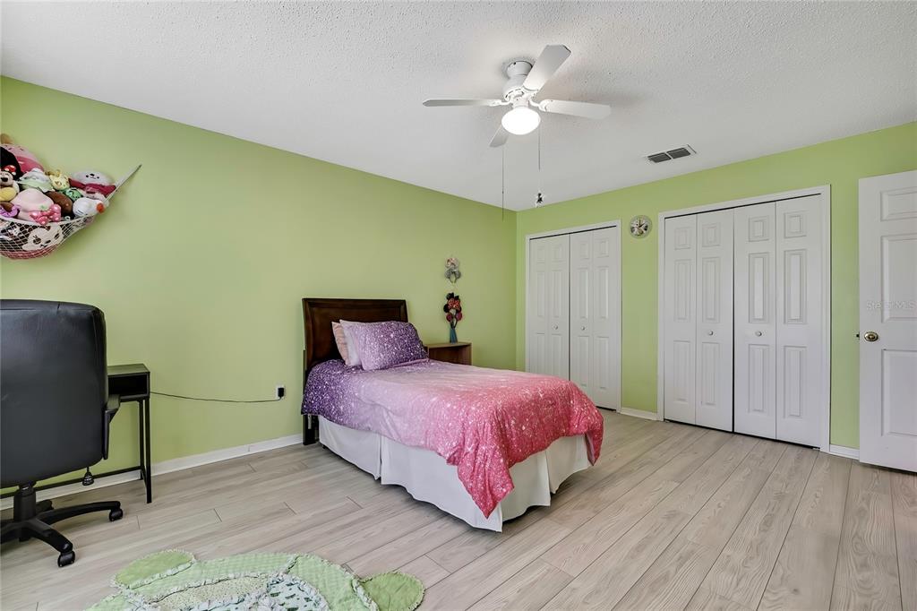 11257 Persimmon Avenue Weeki Wachee, FL 34614 - Photo 24 of 50 a bedroom with a bed dresser and a window