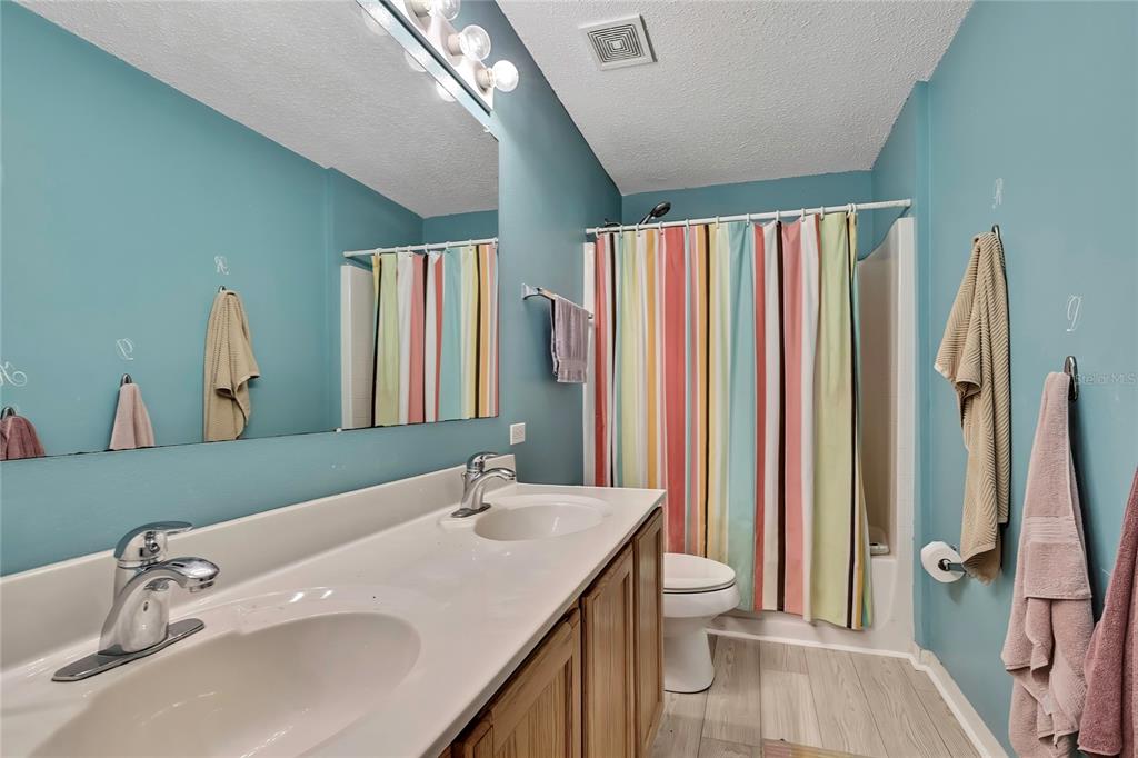 11257 Persimmon Avenue Weeki Wachee, FL 34614 - Photo 25 of 50 a bathroom with a sink a toilet and a mirror