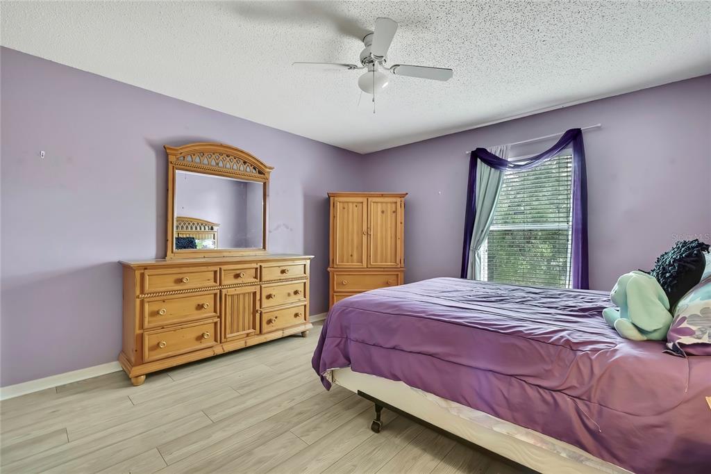 11257 Persimmon Avenue Weeki Wachee, FL 34614 - Photo 28 of 50 a bedroom with a bed and a dresser
