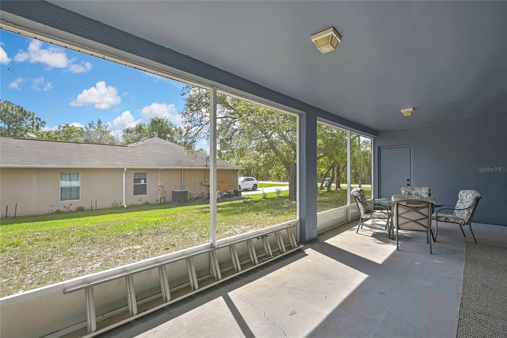 11257 Persimmon Avenue Weeki Wachee, FL 34614 - Photo 32 of 50 a living room with large windows