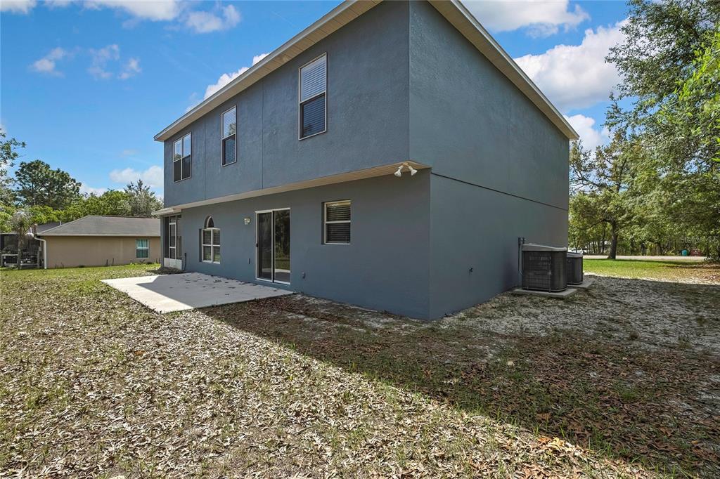11257 Persimmon Avenue Weeki Wachee, FL 34614 - Photo 35 of 50 a backyard of a house with lots of green space