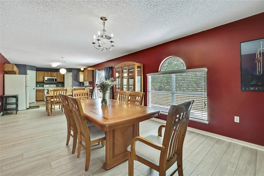 11257 Persimmon Avenue Weeki Wachee, FL 34614 - Photo 44 of 50 a view of a dining room with furniture window and wooden floor