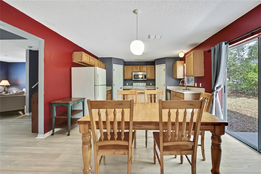 11257 Persimmon Avenue Weeki Wachee, FL 34614 - Photo 45 of 50 a view of a dining room with furniture window and wooden floor