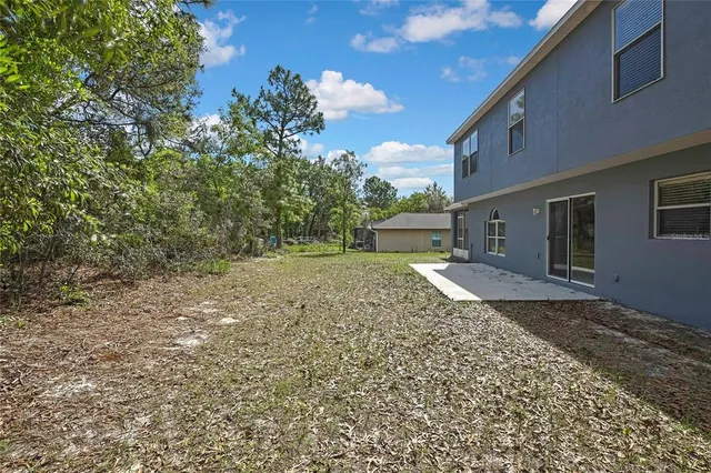 an aerial view of a house with a yard and lake view