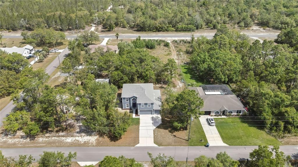 11257 Persimmon Avenue Weeki Wachee, FL 34614 - Photo 50 of 50 an aerial view of a house with a yard and lake view