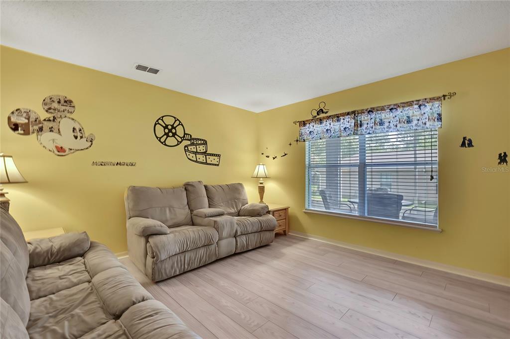 11257 Persimmon Avenue Weeki Wachee, FL 34614 - Photo 6 of 50 a living room with furniture and a window