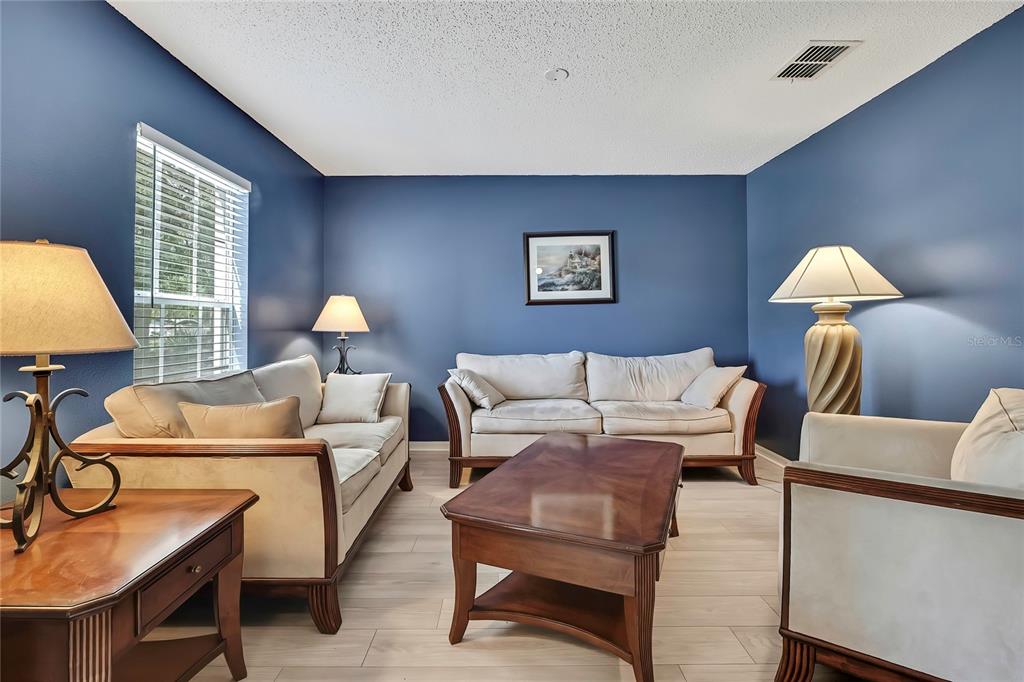 11257 Persimmon Avenue Weeki Wachee, FL 34614 - Photo 10 of 50 a living room with furniture and a lamp
