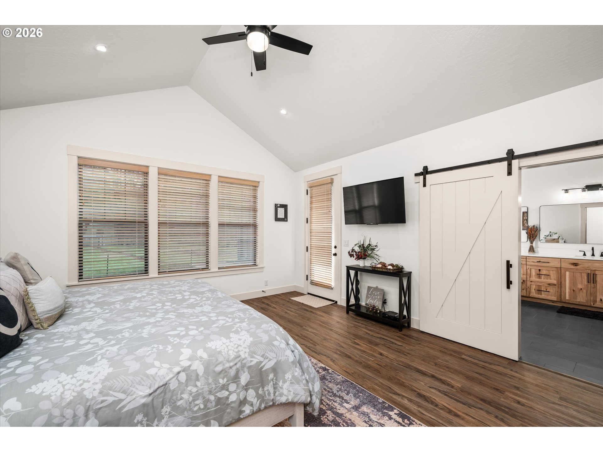 37640 Upper Camp Creek Road Springfield, OR 97478 - Photo 24 of 47 a spacious bedroom with a bed and a flat screen tv