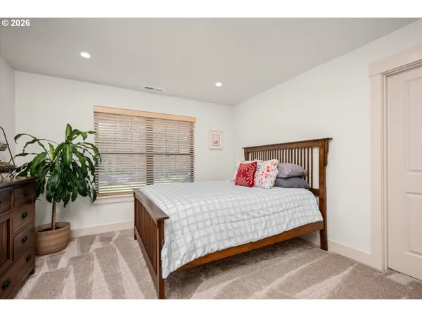 a bedroom with a large bed and a table
