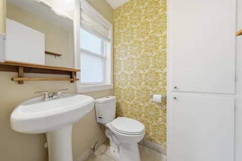a bathroom with a sink a toilet and mirror